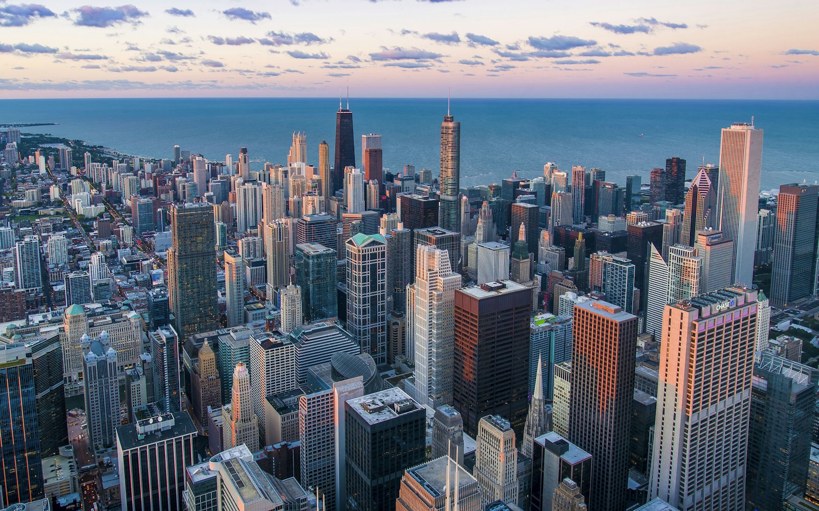 A dense city skyline seen from above at dusk