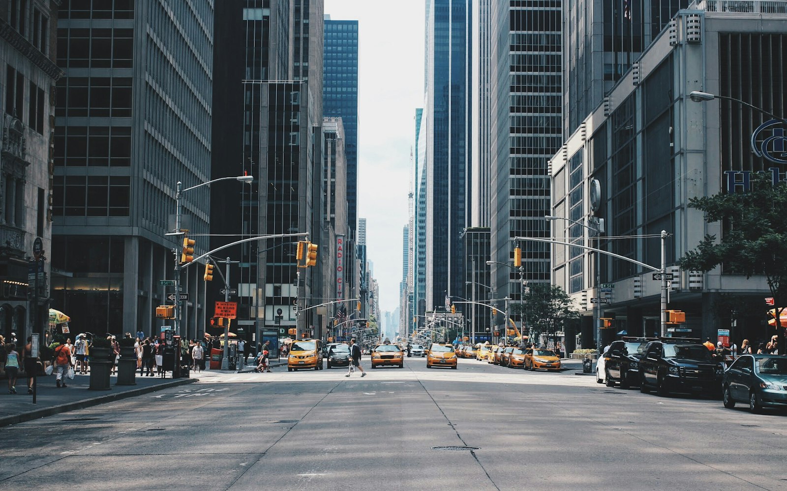A wide boulevard running between dense city buildings