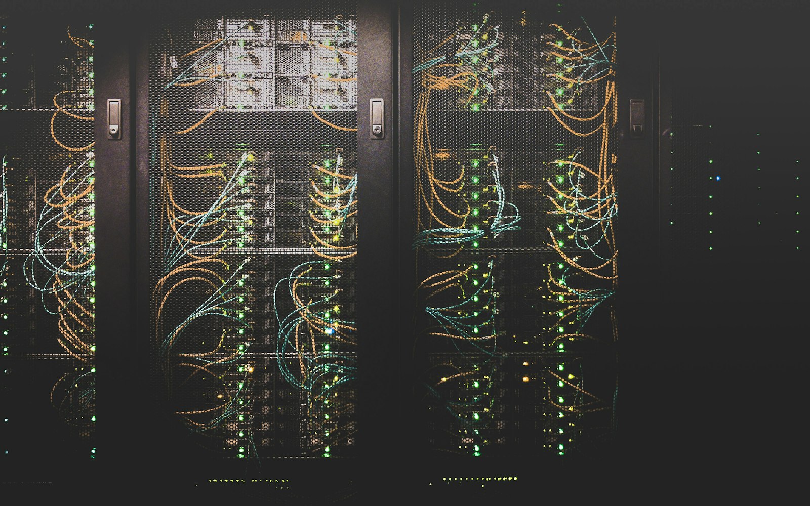 Rows of network servers in a dark data room