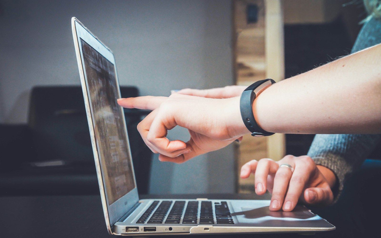 Two people reviewing information on a laptop together