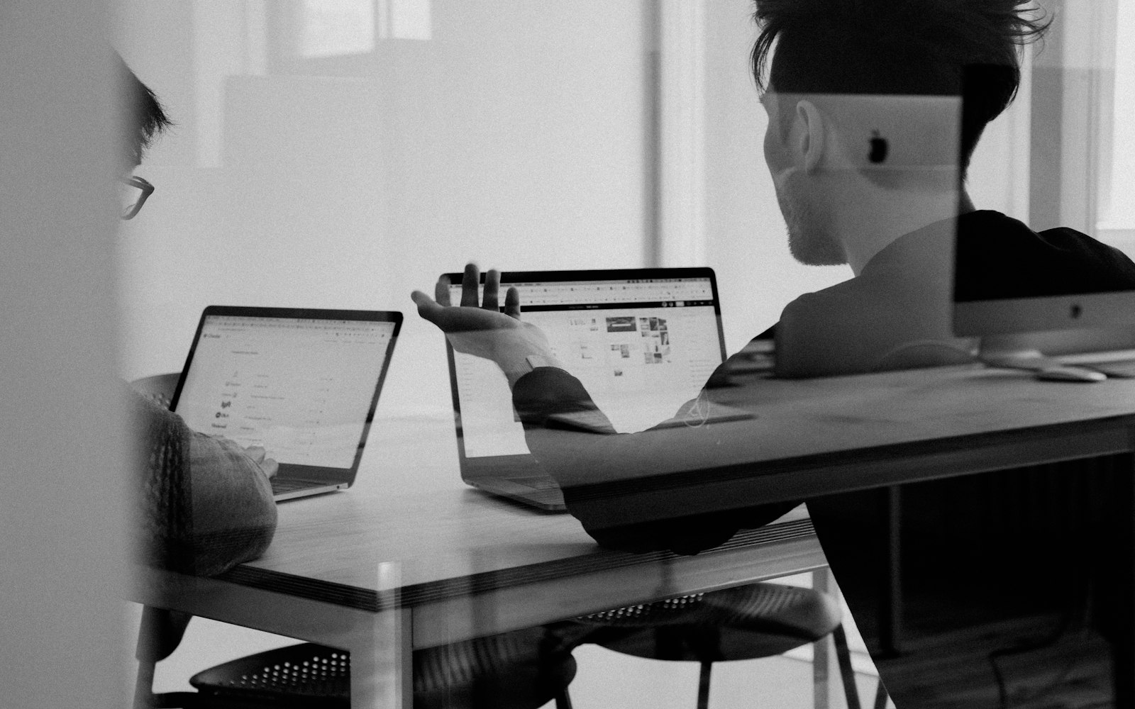 People collaborating at a computer in a small office