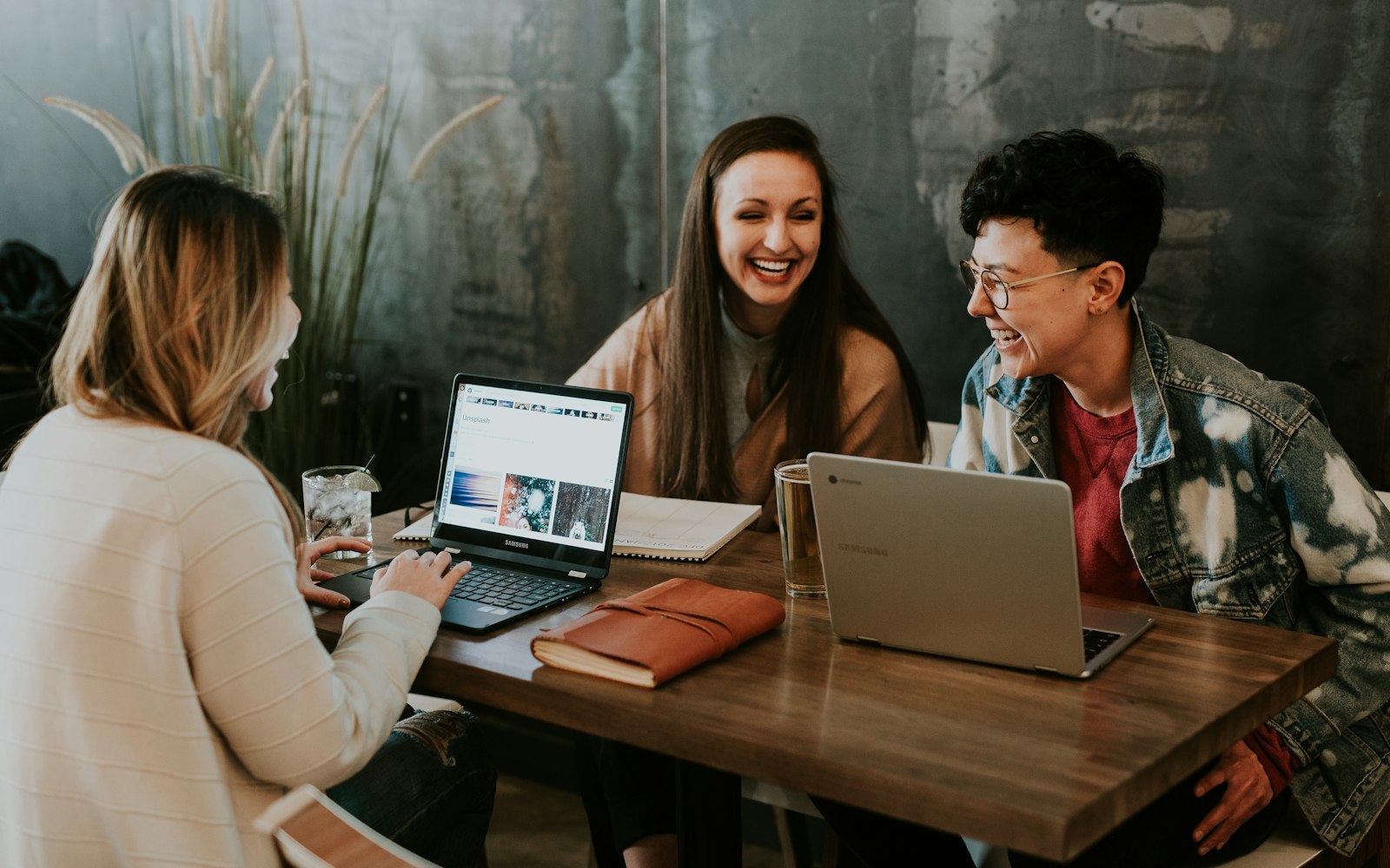 A group of colleagues working with laptops around a table