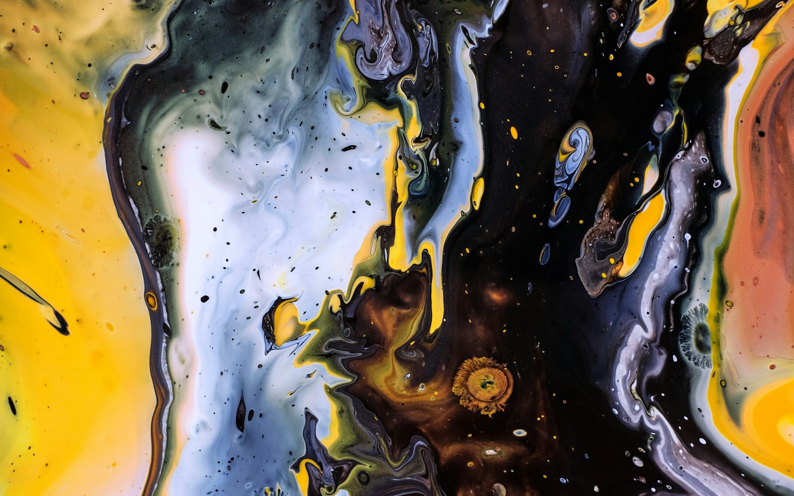 Swirling abstract paint in yellow, black, and white