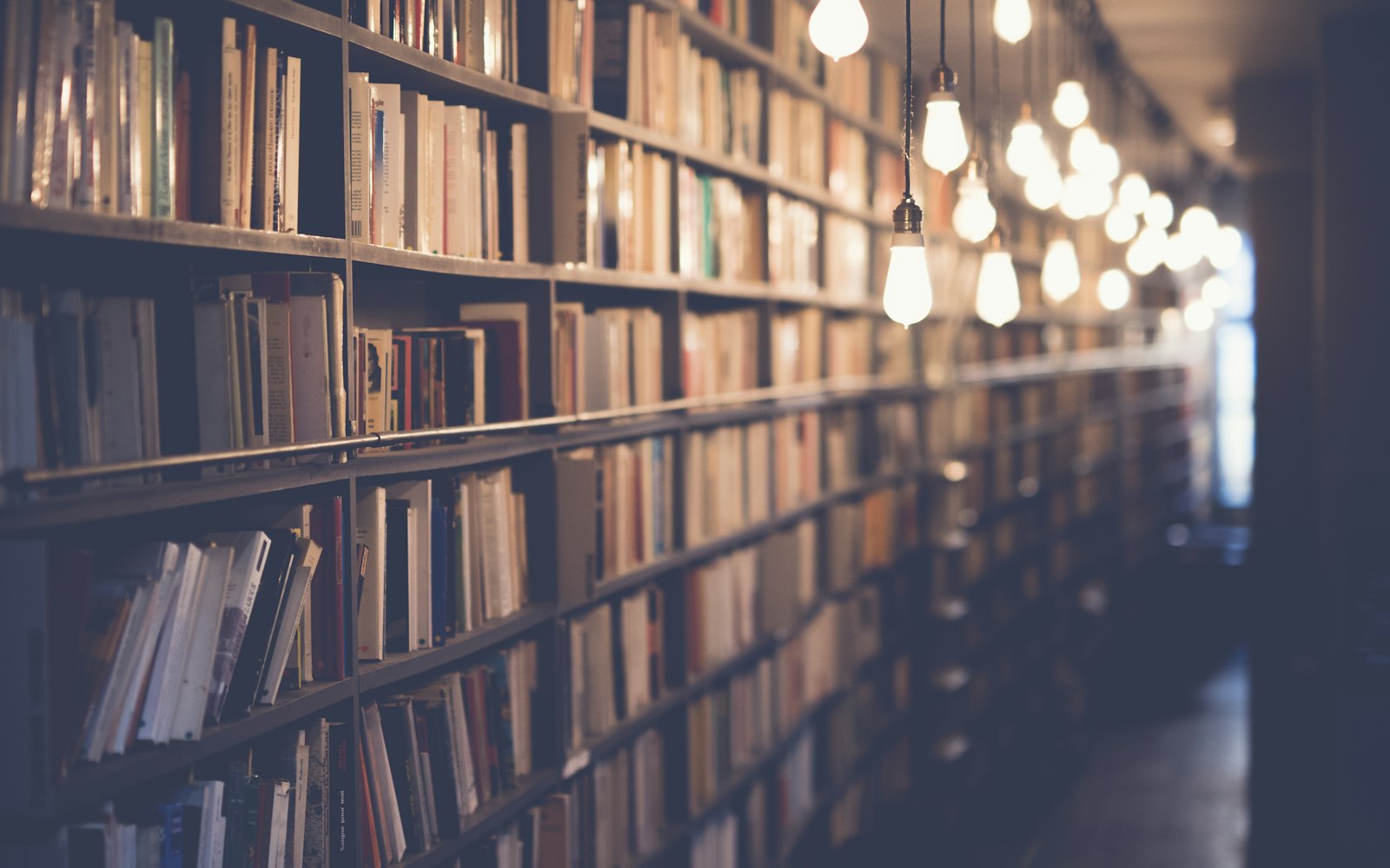 Rows of books in a warm, densely packed library