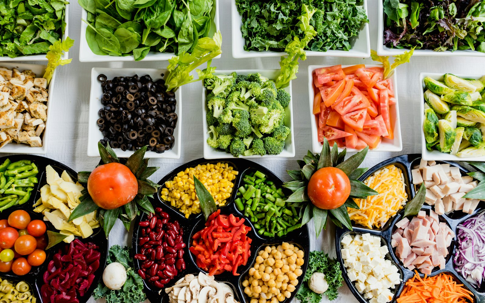An overhead spread of fresh vegetables and prepared ingredients